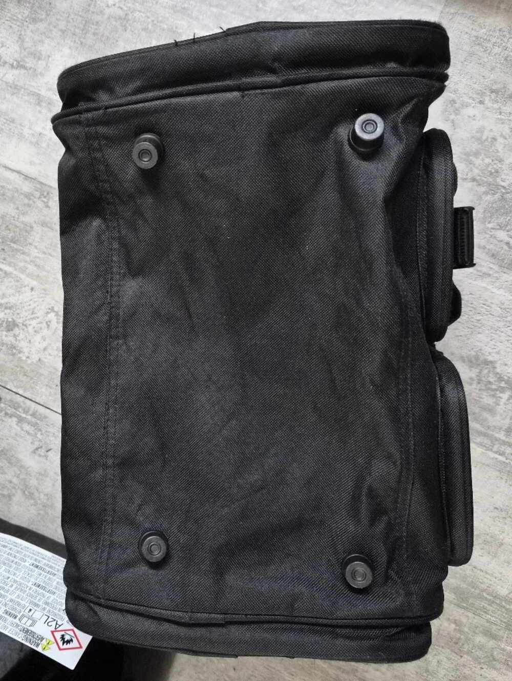 This black Tournamax duffel bag features a prominent logo and secured  pockets